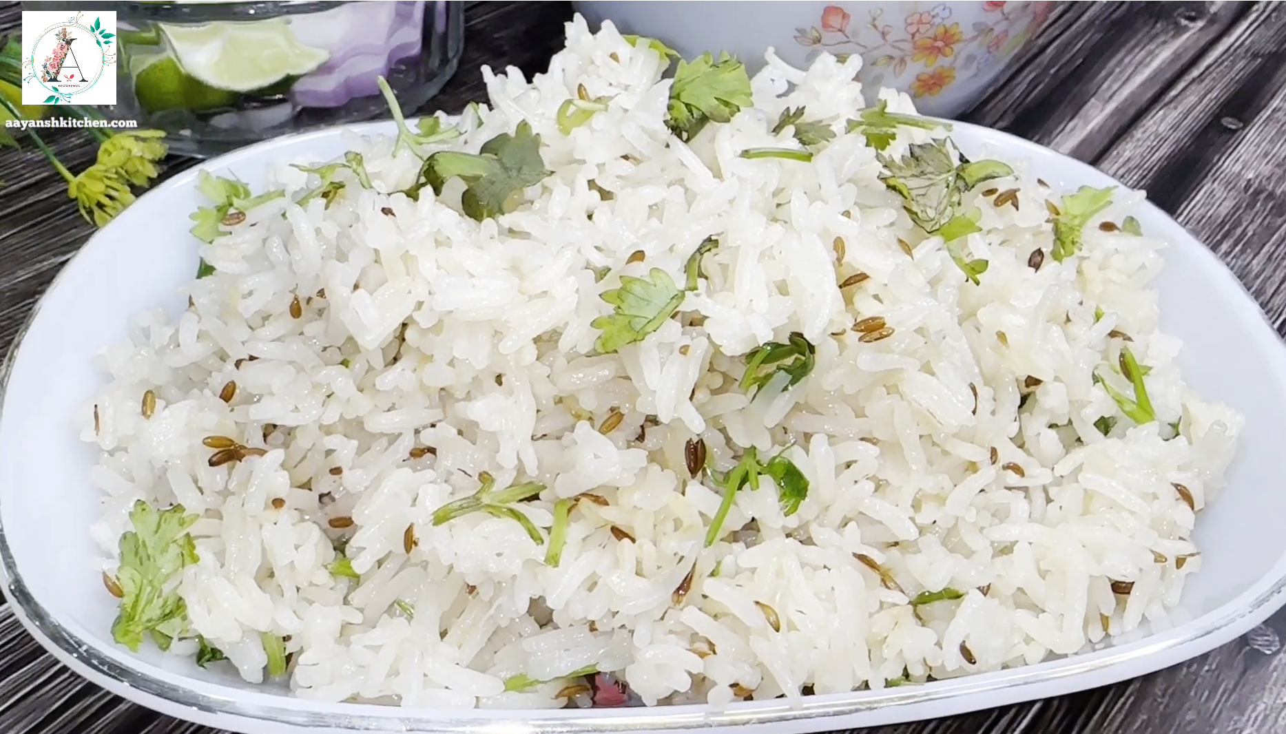 A plate of fluffy Jeera Rice garnished with fresh cilantro leaves.