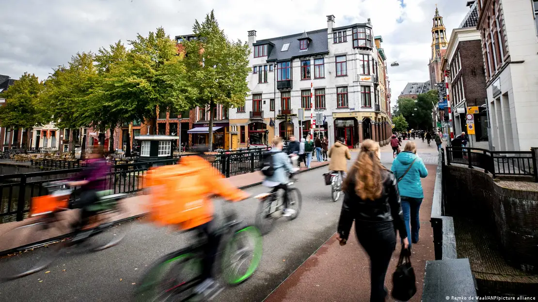 A busy urban bike lane filled with cyclists commuting during rush hour, showcasing a vibrant