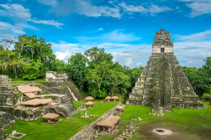 Tikal Temple IV towering over the lush Guatemalan rainforest, showcasing its impressive height and intricate stone carvings