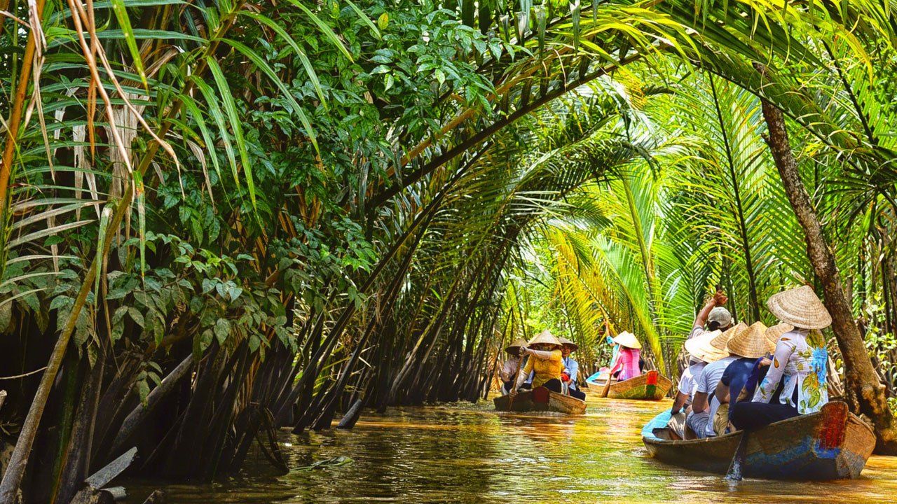 Mekong Delta riverboats navigating rain-soaked waterways 