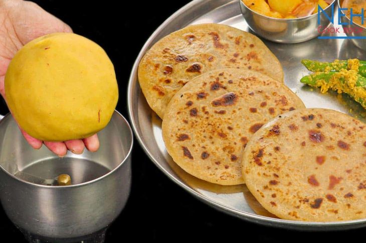 A plate of golden-brown Puran Poli served with a dollop of ghee