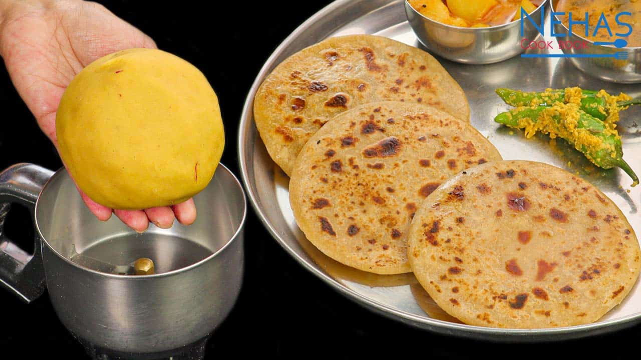 A plate of golden-brown Puran Poli served with a dollop of ghee